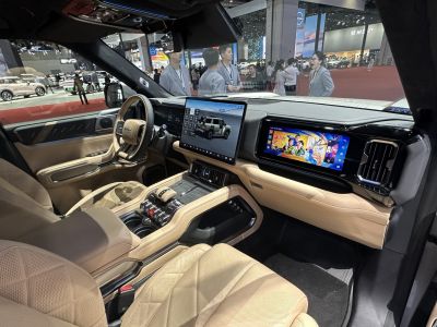 Premium beige leather cabin with dual touchscreen infotainment displays