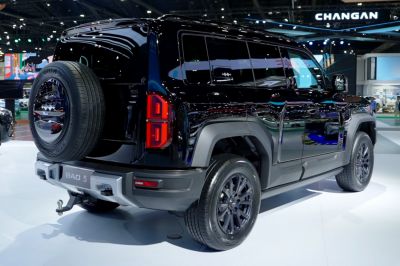 Black SUV with rear mounted spare tire and bold side profile