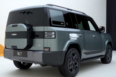 Rear side view of SUV with spare tire mounted on the back and distinct rear lights.