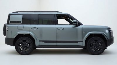 Modern SUV side profile with roof rails and unique wheels