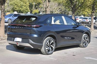 Rear view of electric SUV with full-width LED tail lights and modern design.