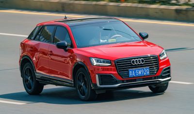 Sporty front grille and LED headlights of red Audi SUV
