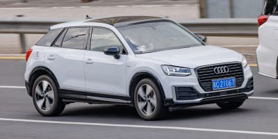 White compact SUV with black roof, sporty grille, and alloy wheels