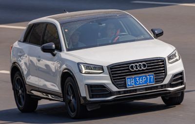 White SUV front with LED headlights and large black grille