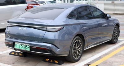 Rear and side view of sleek electric sedan with modern taillights and alloy wheels