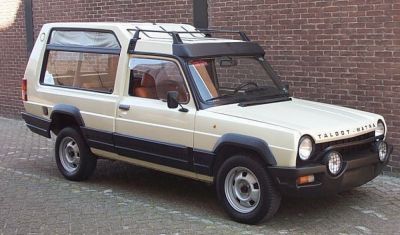 Boxy elevated SUV with round headlights and roof rack