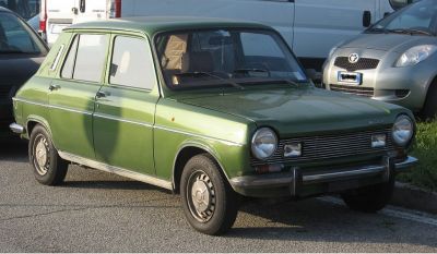 Green hatchback with round headlights and chrome bumpers from the 1960s