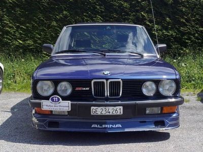 Front view showing quad round headlights and kidney grille