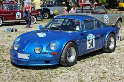 Blue classic sports coupe with round headlights and racing decals