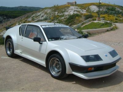 Wedge-shaped white sports coupe with pop-up headlights.