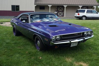 Muscle car front with hood vents and grille.
