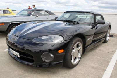Black sports coupe with sleek aerodynamic body and prominent headlights