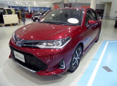Red sedan with sleek front grille and modern headlights