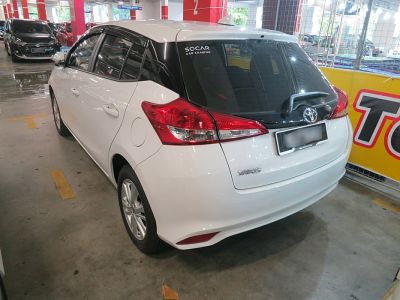 Rear view of white hatchback with distinctive taillights and black rear window trim