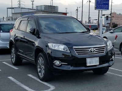 Front view of black SUV with chrome grille and fog lights
