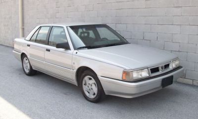 Vintage four-door sedan with distinct front grille and alloy wheels