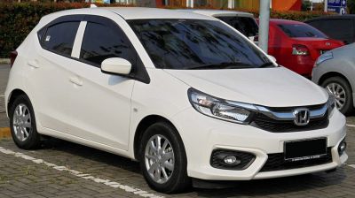 White compact hatchback with sleek headlights and sporty front design