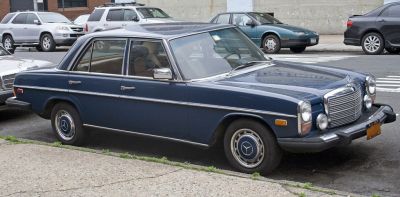 Vintage sedan with round headlights and chrome grille design