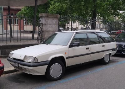 Angular white station wagon with smooth wheel covers and classic 1980s design.