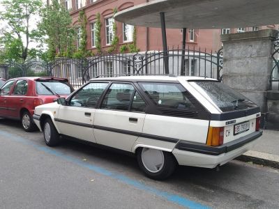 White station wagon with aerodynamic wheel covers and angular hatchback design.