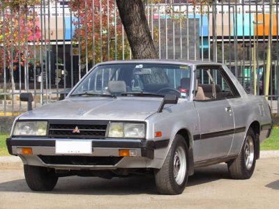 Classic 1970s two-door coupe with side mirrors and distinct front grille