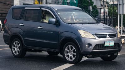 Front-side view of an SUV with detailed headlights and alloy wheels