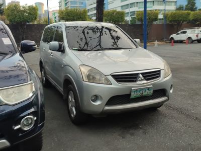 Front angled view of mid-size SUV with distinctive headlights and grille