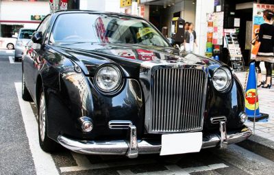 Vintage-style round headlights and prominent chrome vertical grille