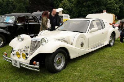 Retro-style classic vintage car with round headlights and prominent front fenders