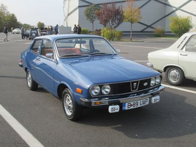 Blue classic four-door sedan with dual round headlights and chrome bumpers