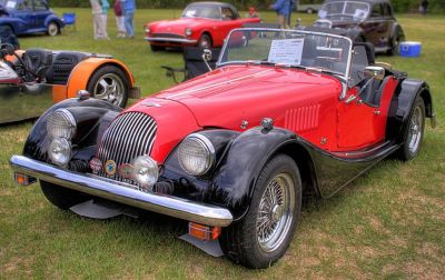 Classic roadster with dual round headlights and wire wheels