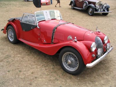 Open-top vintage sports vehicle with wire wheels and classic retro styling