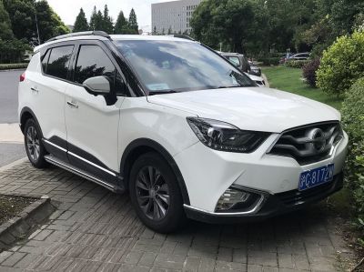 Front-side view of SUV showing LED headlights and distinctive grille