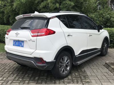 Rear and side view of SUV with roof spoiler and tinted windows