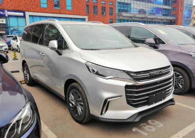 Front grille and LED headlights of silver minivan