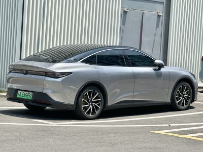 Sleek rear-side view of a modern electric sedan with tinted windows and alloy wheels