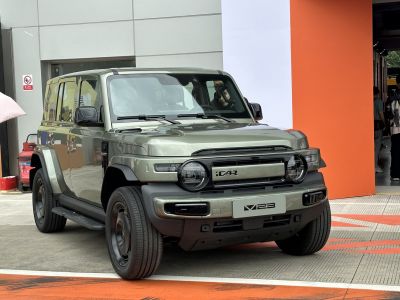 Front view of a rugged SUV with round LED headlights and wide wheel arches