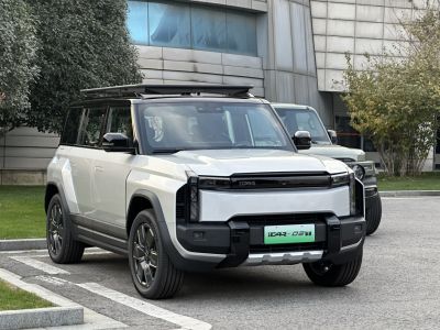 Angular SUV front with rectangular headlights and roof rack