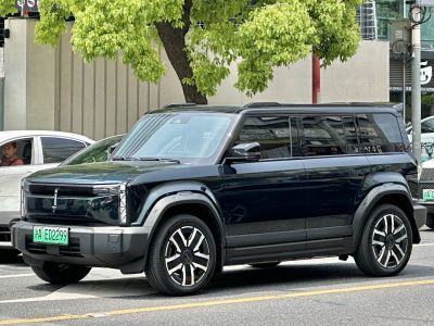 Front side view of sleek boxy electric SUV with multi-spoke wheels