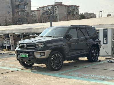 Black SUV plugged into electric charging station in urban area