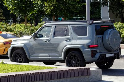 Rear side profile of SUV with spare tire cover and rugged design