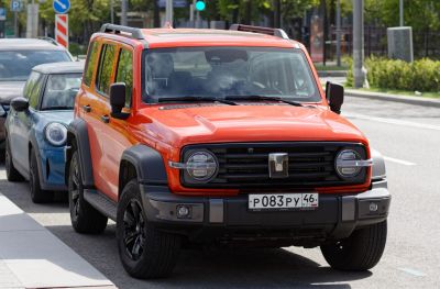 Front view of SUV with round LED headlights and roof rails