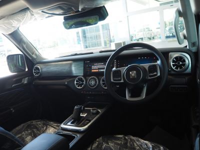 Dashboard and steering wheel with digital displays and round vents