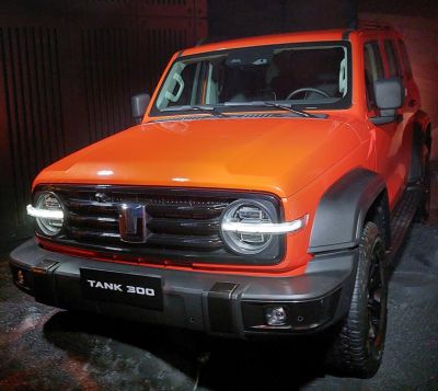 Front view with round LED headlights and black horizontal slat grille