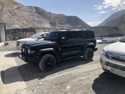 Black SUV with rugged off-road tires and boxy design