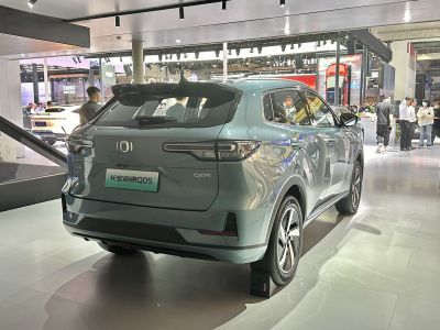 Sleek rear and futuristic tail lights of a modern SUV at an auto show