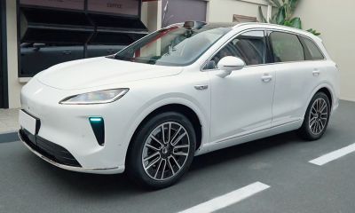 White modern SUV with aerodynamic front side view and alloy wheels