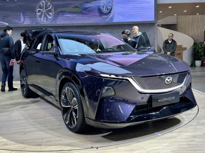 Front view of a sleek electric SUV with distinctive LED headlights and modern wheels