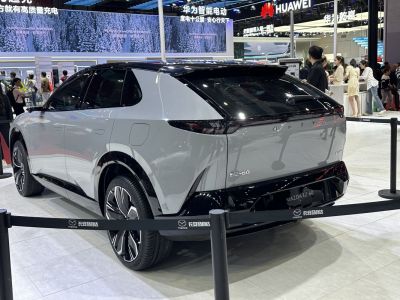 Rear and side view of a sleek, futuristic electric SUV with aerodynamic curves.