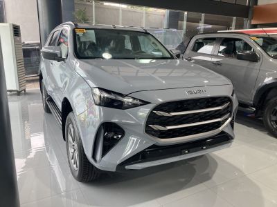 Front angled view with hexagonal grille and sharp headlights